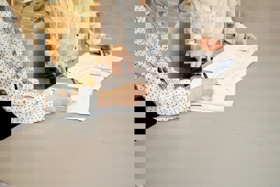 Two people making notes on several pieces of paper