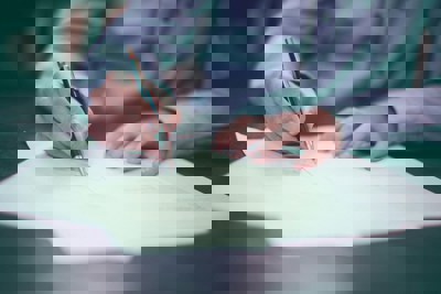 Businessman making notes on paper